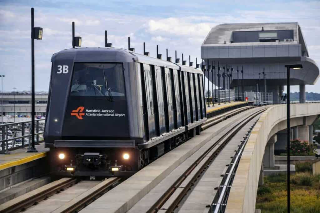 Automated people mover train at airport terminal station with platform screen doors
